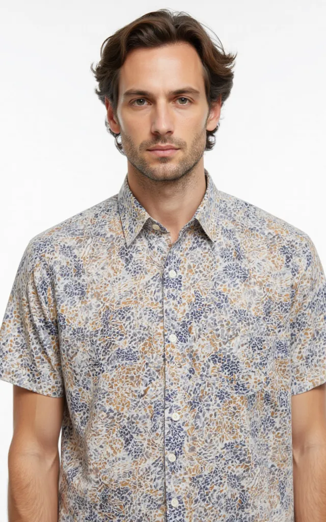 A French model wearing a Mosaic pattern   printed shirt, against a white background, in a front   facing bust portrait